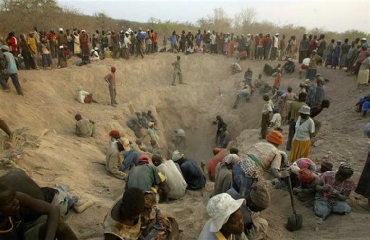Miners dig for diamonds in Marange, eastern Zimbabwe. The African country began selling millions of carats of rough diamonds Wednesday that were mined from an area where human rights groups say soldiers killed 200 people, raped women and forced children into hard labor. 